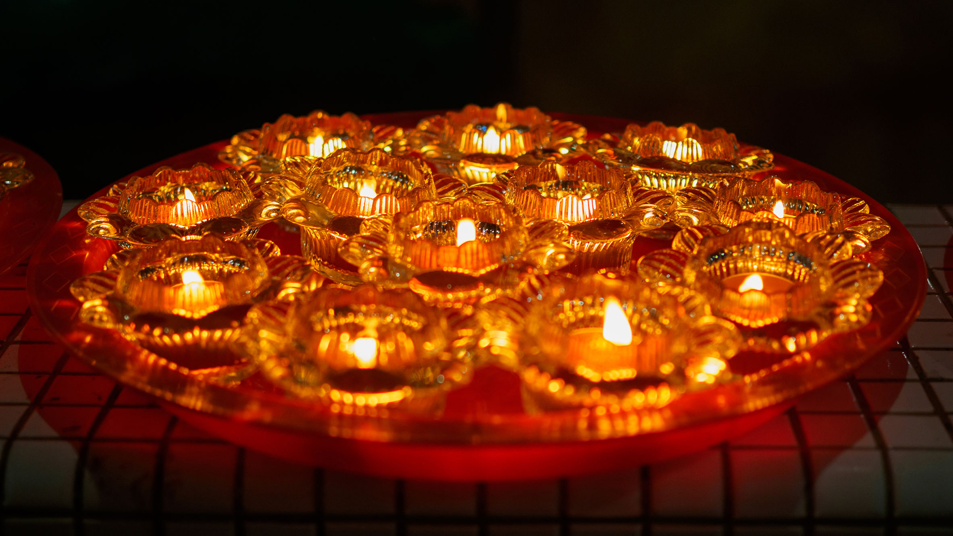 Why do devotees perform good deeds on Vesak Day? What's the significance of offering joss sticks and flowers?