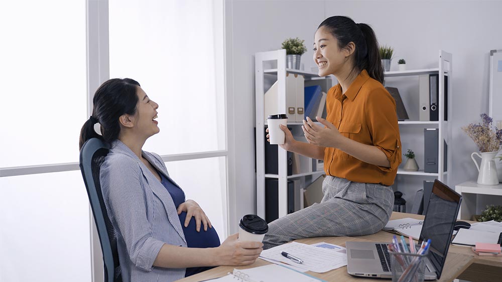 pregnant coworker laughing