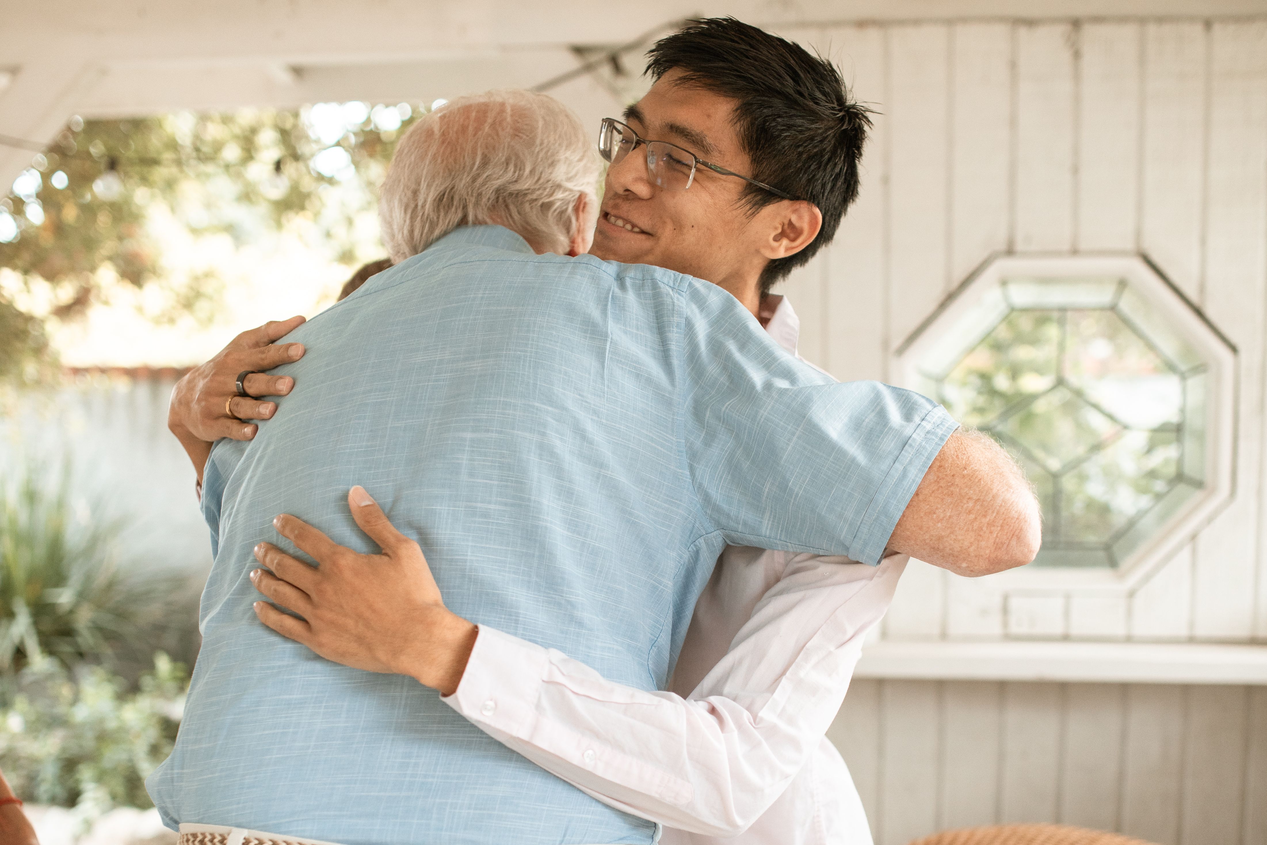 caring for parents in Singapore son hugging father